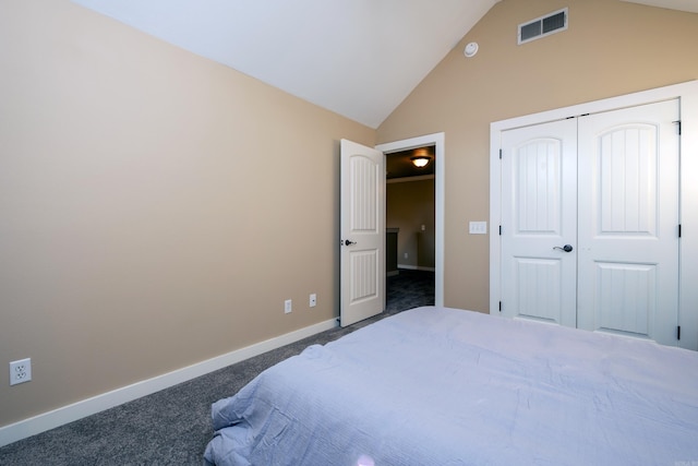 bedroom featuring a closet, vaulted ceiling, and dark carpet