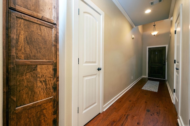 entryway featuring ornamental molding and dark hardwood / wood-style flooring