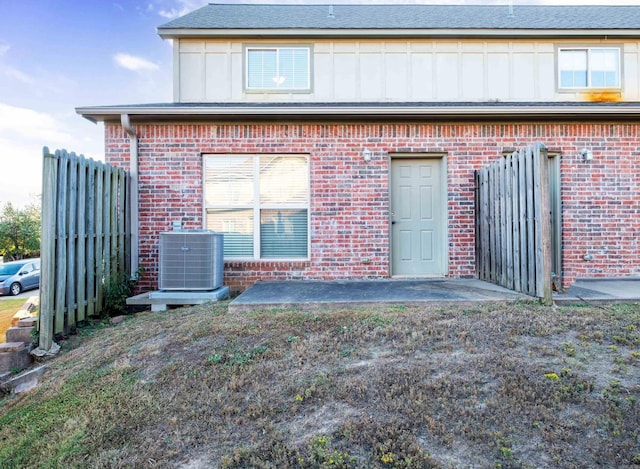 back of house featuring central AC unit