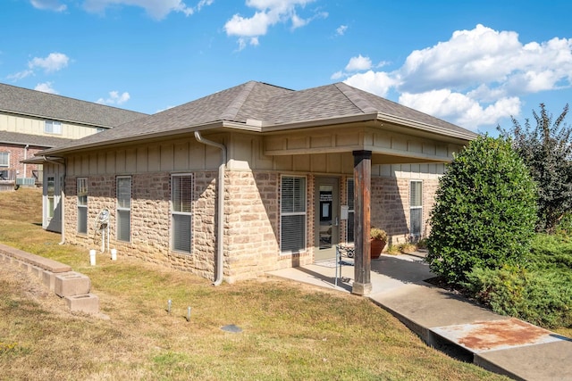 exterior space featuring a front lawn and a patio area