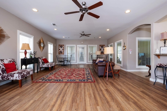 living room featuring ceiling fan, a healthy amount of sunlight, and wood-type flooring