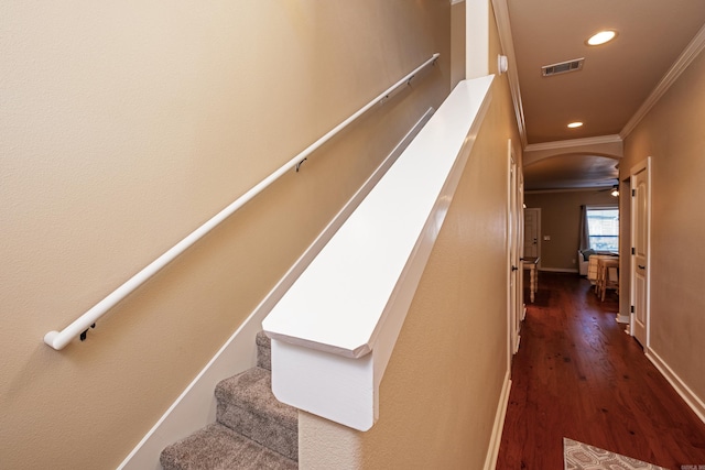 stairway featuring ornamental molding, wood-type flooring, and ceiling fan