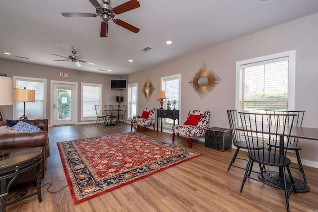 living room featuring hardwood / wood-style floors, ceiling fan, and a wealth of natural light