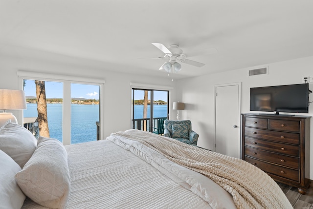 bedroom featuring access to outside, multiple windows, hardwood / wood-style flooring, and ceiling fan