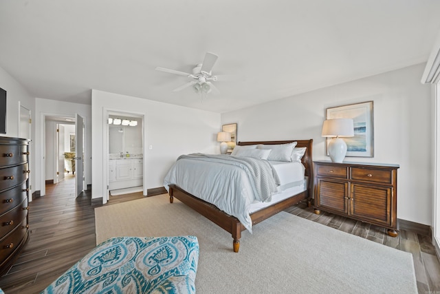 bedroom with dark wood-type flooring, ensuite bathroom, and ceiling fan