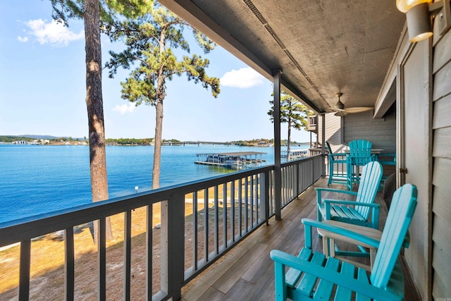 balcony with a water view and ceiling fan