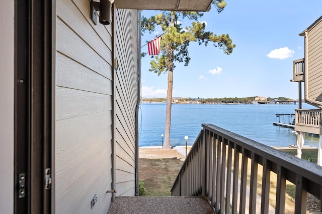 view of dock featuring a balcony and a water view