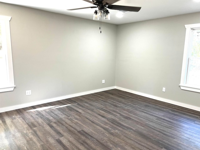 unfurnished room with dark wood-type flooring and ceiling fan