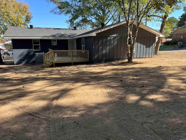 back of house featuring a wooden deck