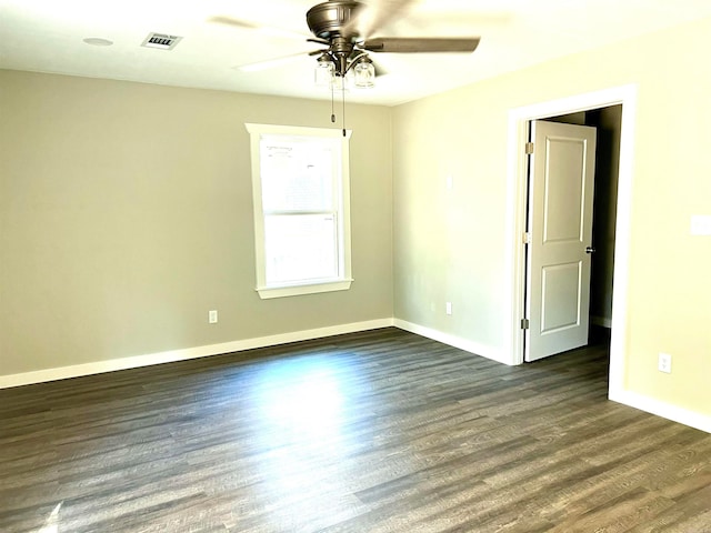 unfurnished room featuring dark hardwood / wood-style floors and ceiling fan