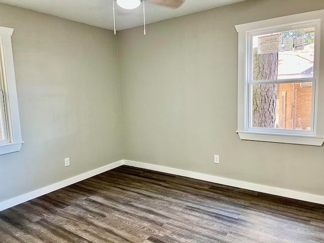 spare room with dark wood-type flooring and ceiling fan