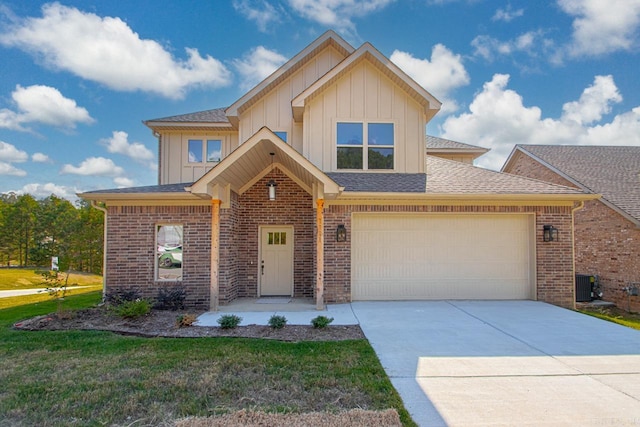 view of front of home with a front yard, a garage, and cooling unit