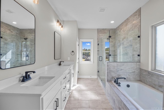 bathroom featuring vanity, independent shower and bath, and plenty of natural light