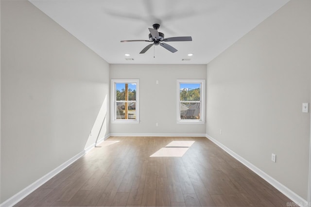 empty room with hardwood / wood-style flooring and ceiling fan