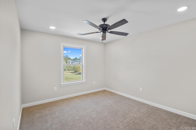 unfurnished room featuring ceiling fan and carpet flooring