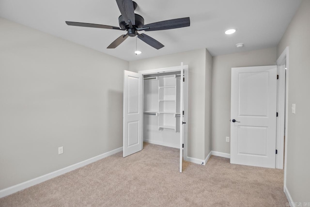 unfurnished bedroom with a closet, ceiling fan, and light colored carpet