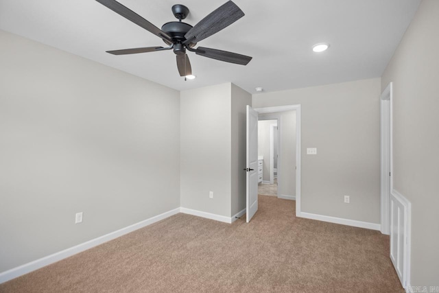 unfurnished bedroom featuring light colored carpet and ceiling fan