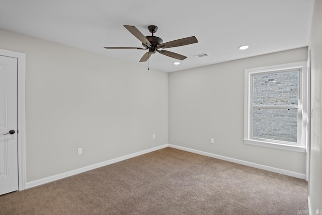 empty room with ceiling fan and carpet flooring