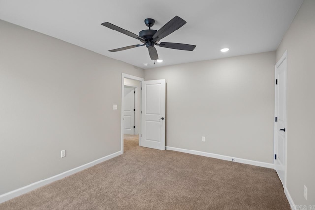 spare room featuring carpet floors and ceiling fan