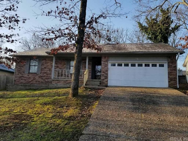 ranch-style house featuring a porch and a garage