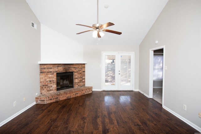 unfurnished living room featuring a fireplace, french doors, dark hardwood / wood-style flooring, ceiling fan, and high vaulted ceiling