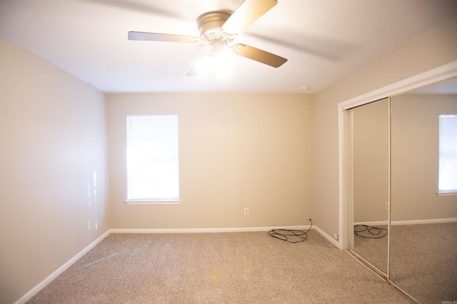 unfurnished bedroom with a closet, carpet, and ceiling fan