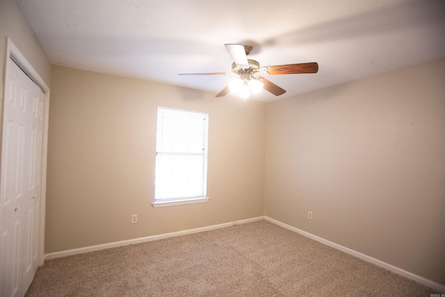 empty room with ceiling fan and carpet floors