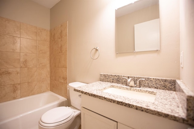 full bathroom with vanity, tiled shower / bath, and toilet