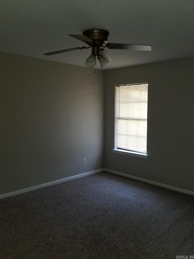 spare room with carpet floors and ceiling fan