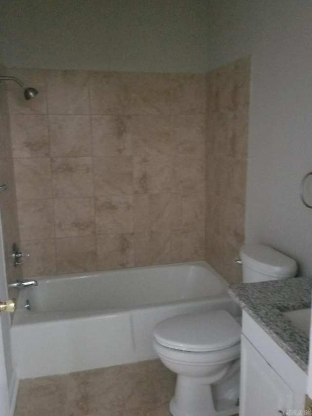 full bathroom featuring vanity, tiled shower / bath combo, and toilet