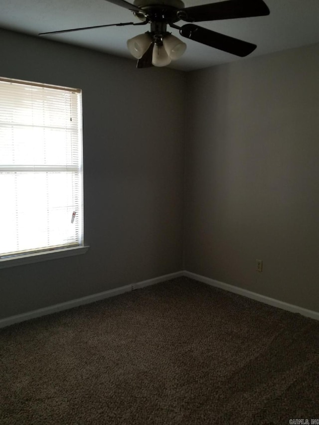 empty room with ceiling fan and carpet floors