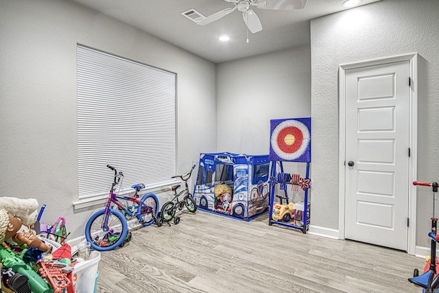 rec room featuring ceiling fan and light wood-type flooring