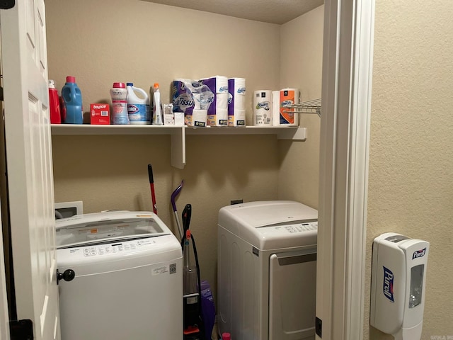 clothes washing area featuring a textured ceiling and separate washer and dryer