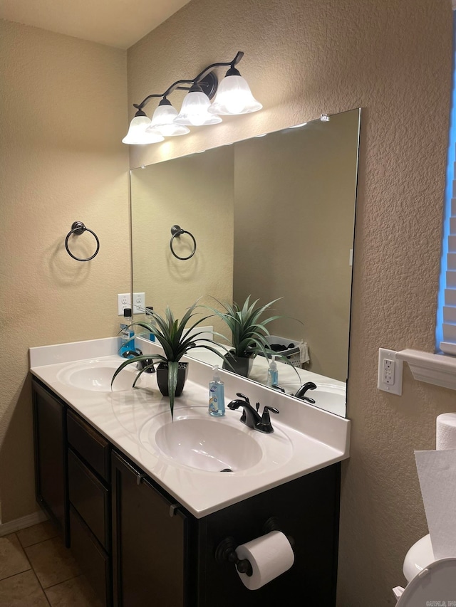 bathroom with vanity, toilet, and tile patterned flooring