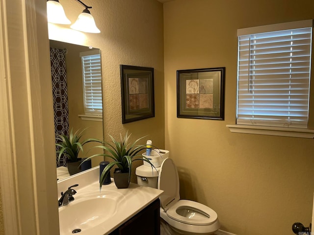 bathroom featuring toilet and vanity