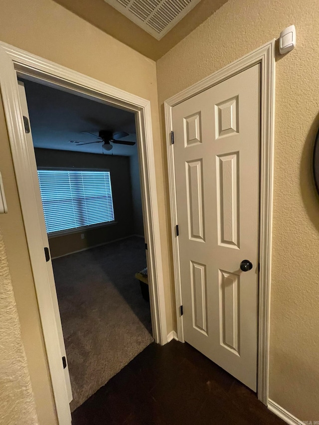 corridor with dark colored carpet