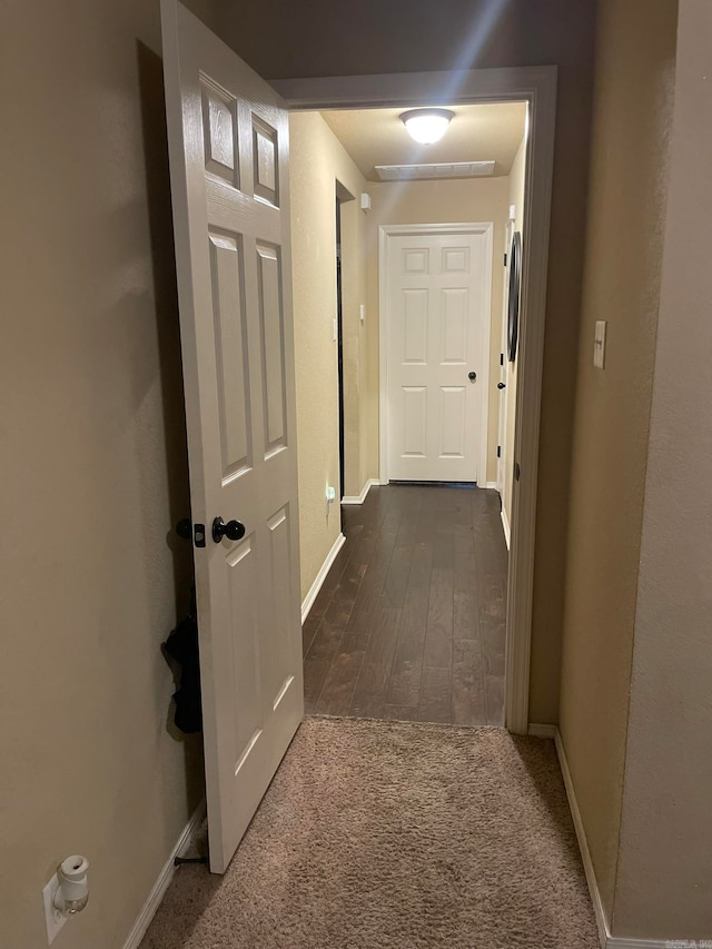 hallway with dark wood-type flooring