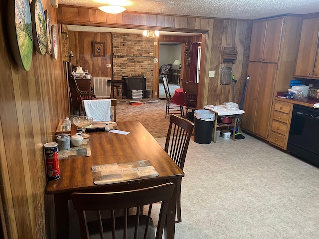 dining space featuring light carpet and wood walls