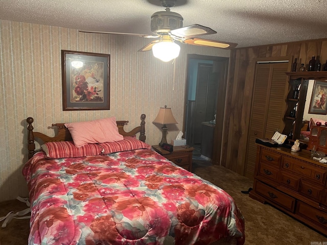 bedroom with a closet, ceiling fan, a textured ceiling, and dark colored carpet