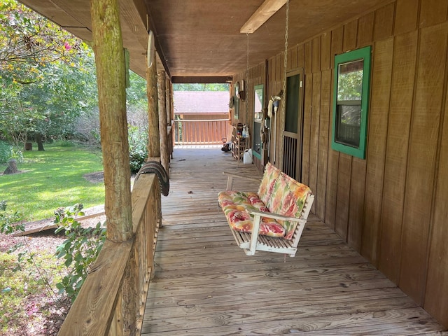 deck with covered porch and a lawn