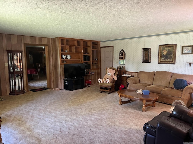 living room featuring carpet flooring, a textured ceiling, and wooden walls