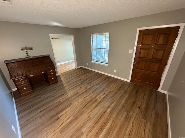 foyer entrance featuring a textured ceiling and hardwood / wood-style flooring