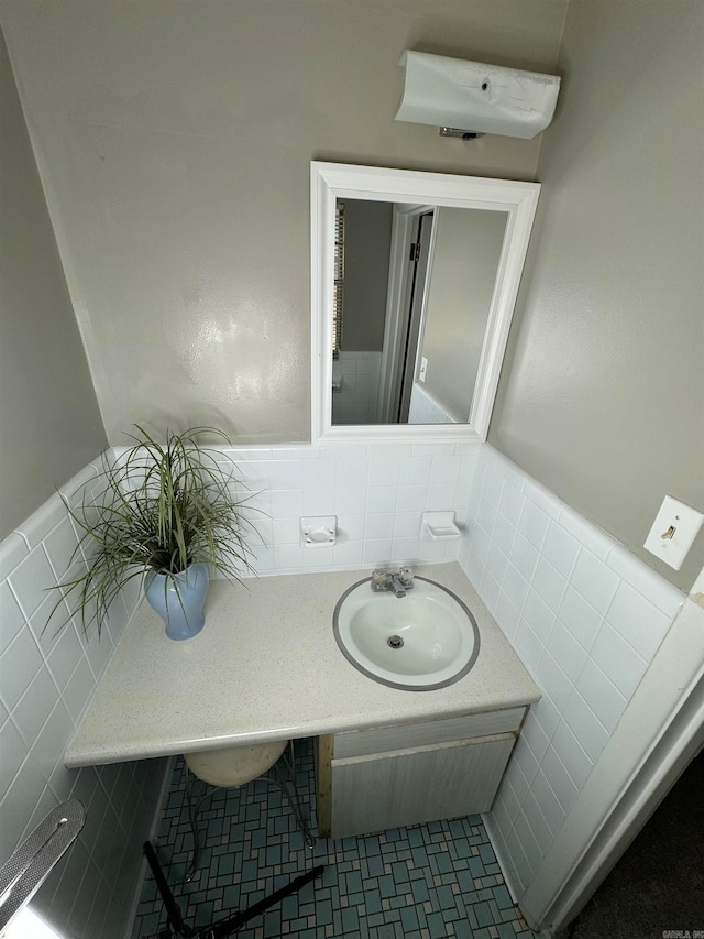 bathroom with tile walls, vanity, and tile patterned flooring