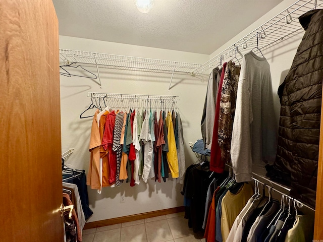 spacious closet with light tile patterned floors