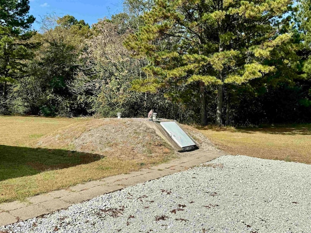 view of storm shelter featuring a lawn