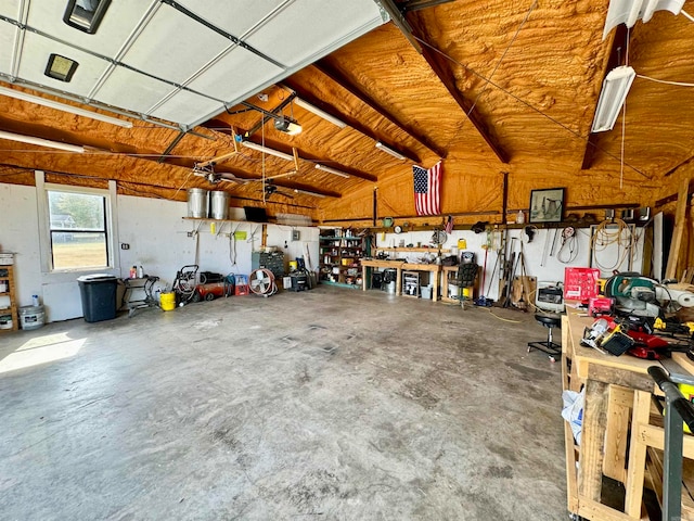 garage with a garage door opener and a workshop area