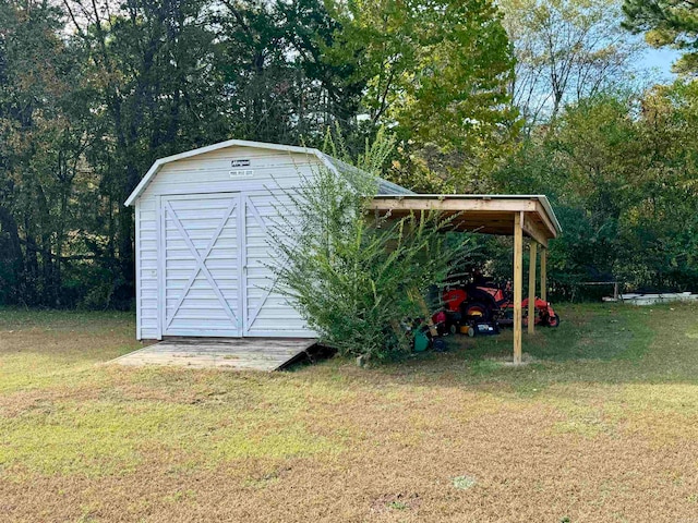 view of outbuilding with a lawn and a carport