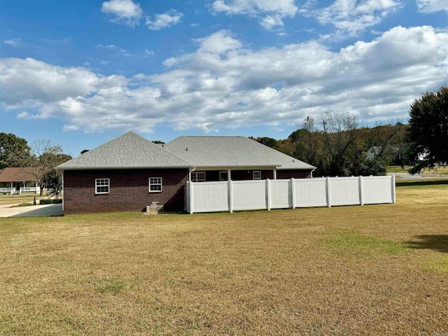 rear view of property with a yard