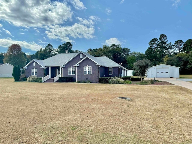 single story home with an outdoor structure, a front yard, and a garage