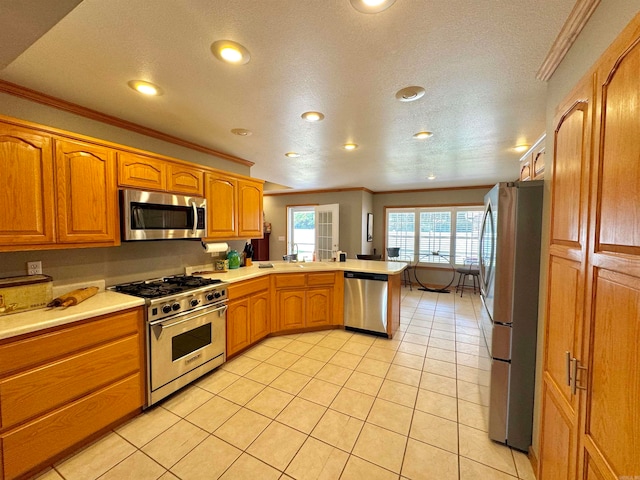 kitchen featuring crown molding, appliances with stainless steel finishes, kitchen peninsula, and light tile patterned floors